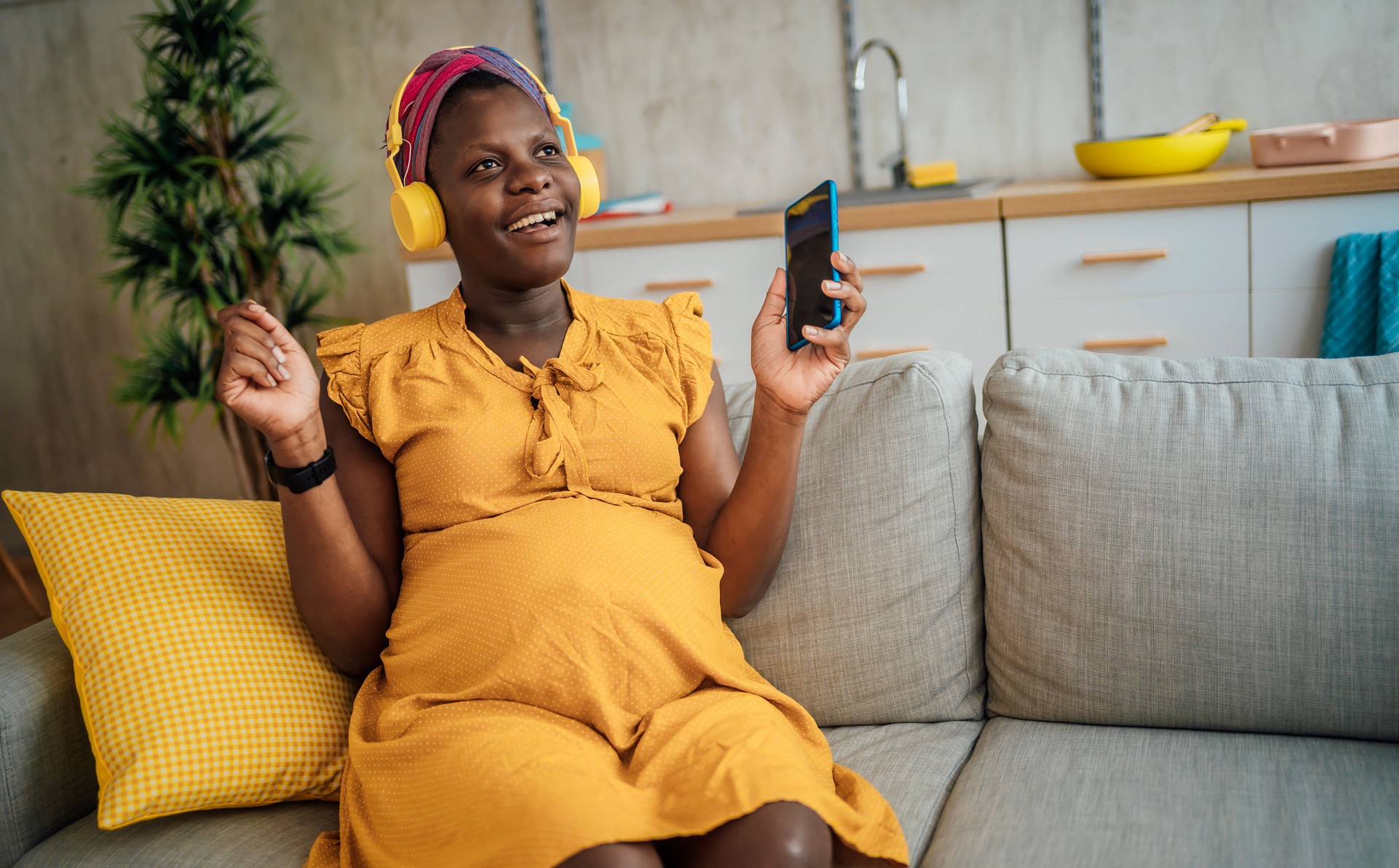 Pregnant woman listening to music on headphones